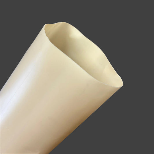 Close-up of a beige single-wall HDPE grow tube with a 3.5-inch diameter, ideal for protecting young trees in orchards and vineyards